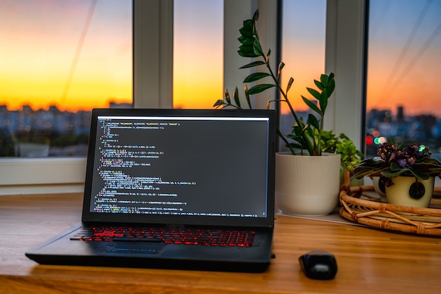 [freepicdownloader.com]-young-male-developer-is-programming-code-script-late-night-with-beautiful-city-lights-normal